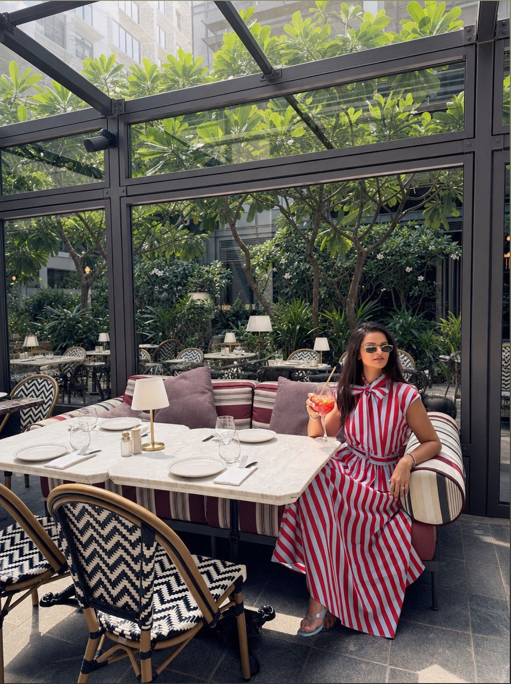 Aastha Chopra — courtyard brunch at a luxury Dubai restaurant